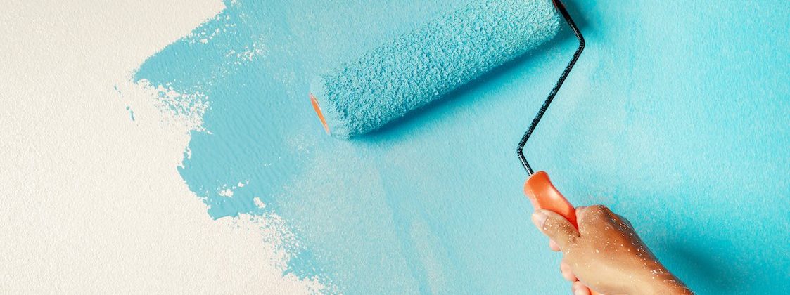 Roller Brush Painting, Worker painting on surface wall  Painting apartment, renovating with blue color paint.